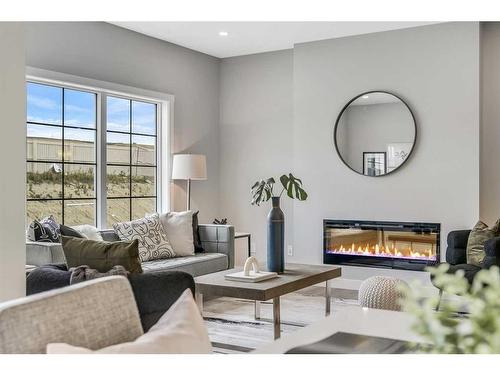 1378 Bayview Crescent Sw, Airdrie, AB - Indoor Photo Showing Living Room With Fireplace