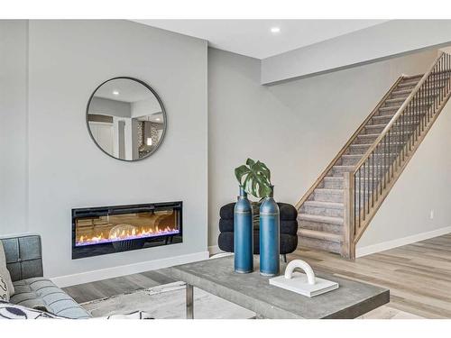 1378 Bayview Crescent Sw, Airdrie, AB - Indoor Photo Showing Living Room With Fireplace