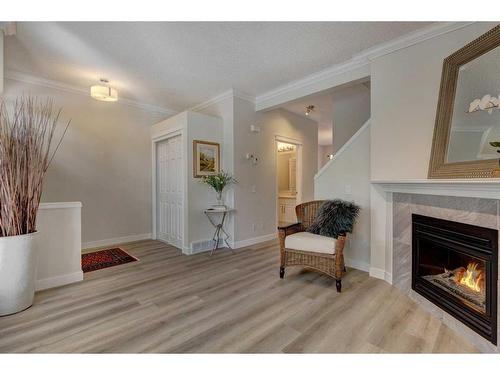 18 Promenade Way Se, Calgary, AB - Indoor Photo Showing Living Room With Fireplace