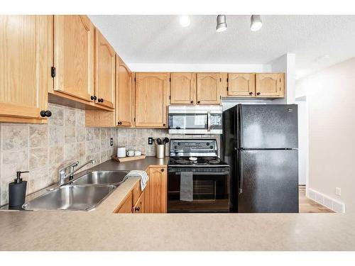 124 Everstone Place Sw, Calgary, AB - Indoor Photo Showing Kitchen With Double Sink