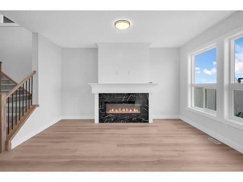 1421 Aldrich Place, Carstairs, AB - Indoor Photo Showing Living Room With Fireplace