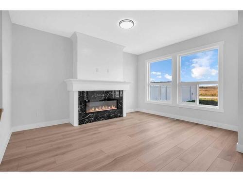 1421 Aldrich Place, Carstairs, AB - Indoor Photo Showing Living Room With Fireplace