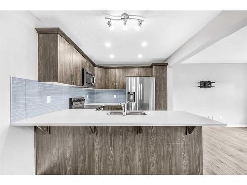 1510 Carrington Blvd, Calgary, AB - Indoor Photo Showing Kitchen With Double Sink With Upgraded Kitchen