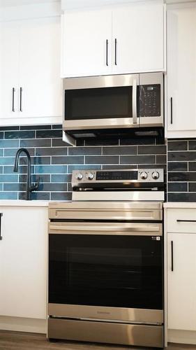 1209 Iron Ridge Avenue, Crossfield, AB - Indoor Photo Showing Kitchen