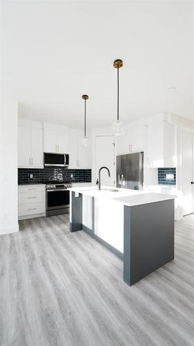 1209 Iron Ridge Avenue, Crossfield, AB - Indoor Photo Showing Kitchen With Upgraded Kitchen