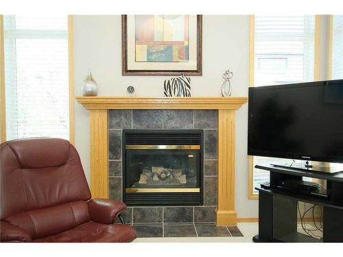 35 Wentworth Gardens Sw, Calgary, AB - Indoor Photo Showing Living Room With Fireplace