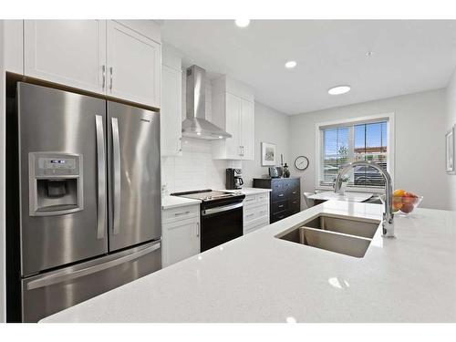 104-8355 19 Avenue Sw, Calgary, AB - Indoor Photo Showing Kitchen With Stainless Steel Kitchen With Double Sink With Upgraded Kitchen