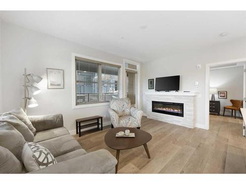 104-8355 19 Avenue Sw, Calgary, AB - Indoor Photo Showing Living Room With Fireplace