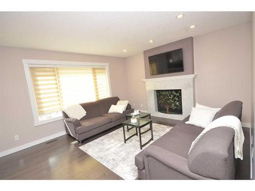 12 Riverside Crescent Se, Calgary, AB - Indoor Photo Showing Living Room With Fireplace