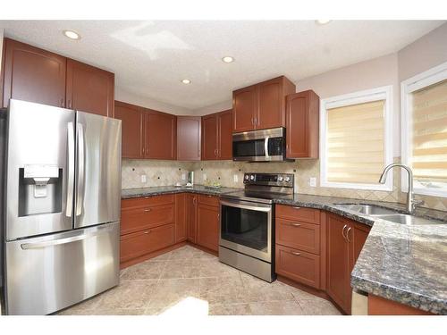 12 Riverside Crescent Se, Calgary, AB - Indoor Photo Showing Kitchen With Stainless Steel Kitchen With Double Sink