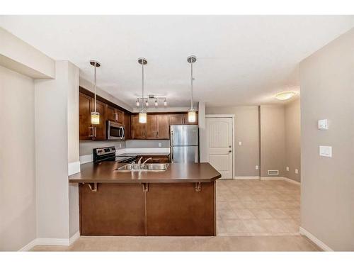 2317-130 Panatella Street Nw, Calgary, AB - Indoor Photo Showing Kitchen With Double Sink