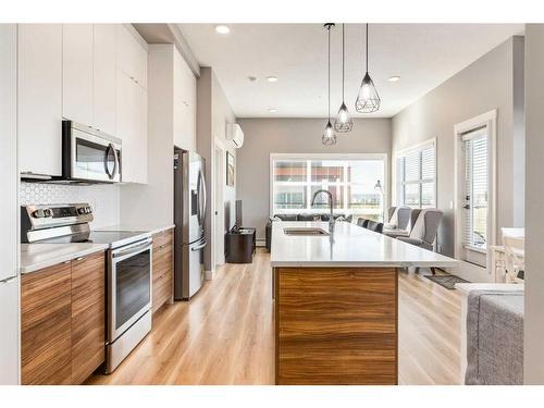 412-19661 40 Street Se, Calgary, AB - Indoor Photo Showing Kitchen With Double Sink With Upgraded Kitchen