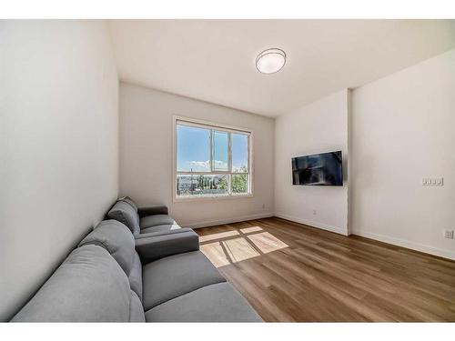 203-101 Panatella Square Nw, Calgary, AB - Indoor Photo Showing Living Room