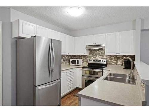 7 Citadel Meadow Gardens Nw, Calgary, AB - Indoor Photo Showing Kitchen With Stainless Steel Kitchen With Double Sink