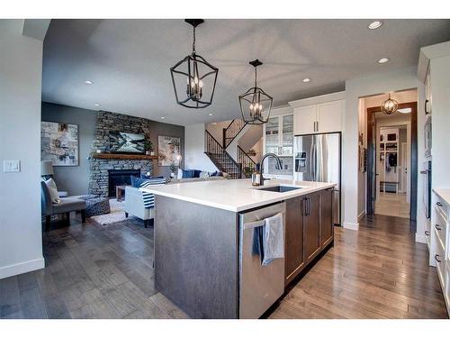 149 Kingsmere Cove Se, Airdrie, AB - Indoor Photo Showing Kitchen With Fireplace With Upgraded Kitchen