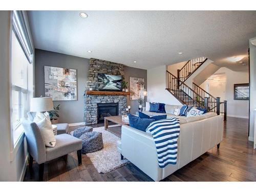 149 Kingsmere Cove Se, Airdrie, AB - Indoor Photo Showing Living Room With Fireplace