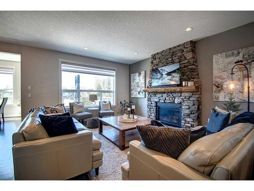 149 Kingsmere Cove Se, Airdrie, AB - Indoor Photo Showing Living Room With Fireplace