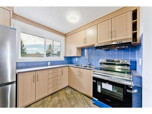 181 Pennsburg Way, Calgary, AB - Indoor Photo Showing Kitchen With Double Sink