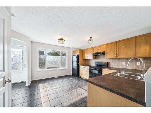 4581 Elgin Avenue Se, Calgary, AB - Indoor Photo Showing Kitchen With Double Sink