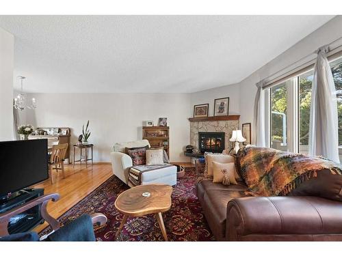 107 Palis Way Sw, Calgary, AB - Indoor Photo Showing Living Room With Fireplace