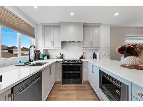 138 Wolf Creek Rise Se, Calgary, AB - Indoor Photo Showing Kitchen With Double Sink With Upgraded Kitchen