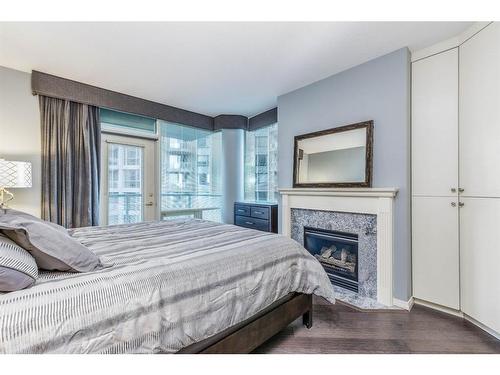 404-837 2 Avenue Sw, Calgary, AB - Indoor Photo Showing Bedroom With Fireplace