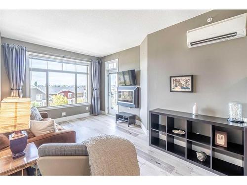 406-10 Auburn Bay Link Se, Calgary, AB - Indoor Photo Showing Living Room