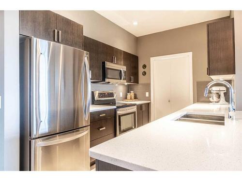 406-10 Auburn Bay Link Se, Calgary, AB - Indoor Photo Showing Kitchen With Double Sink With Upgraded Kitchen