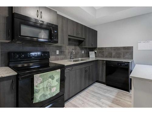 1212-250 Sage Valley Road Nw, Calgary, AB - Indoor Photo Showing Kitchen With Double Sink