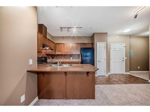 4205-92 Crystal Shores Road, Okotoks, AB - Indoor Photo Showing Kitchen With Double Sink