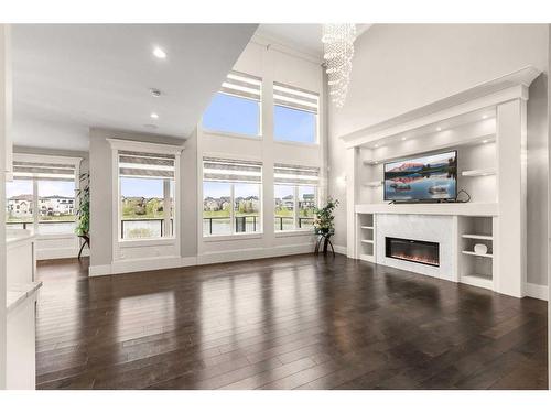 144 Kinniburgh Loop, Chestermere, AB - Indoor Photo Showing Other Room With Fireplace