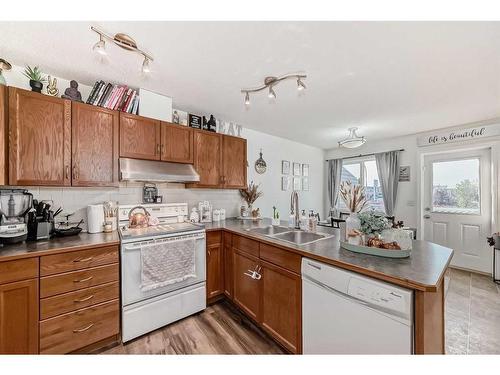 302-800 Yankee Valley Boulevard Se, Airdrie, AB - Indoor Photo Showing Kitchen With Double Sink