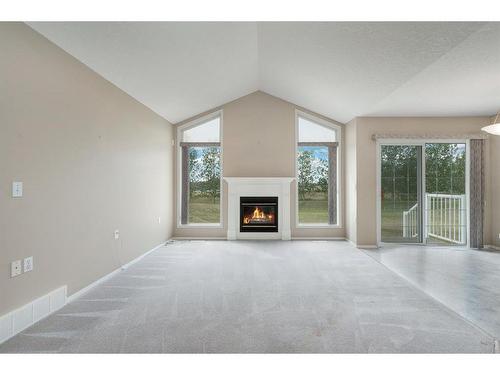 411 Hope Bay, Rural Rocky View County, AB - Indoor Photo Showing Living Room With Fireplace