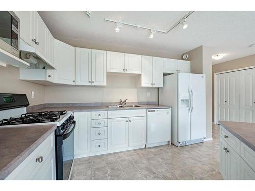 411 Hope Bay, Rural Rocky View County, AB - Indoor Photo Showing Kitchen With Double Sink