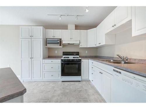 411 Hope Bay, Rural Rocky View County, AB - Indoor Photo Showing Kitchen With Double Sink