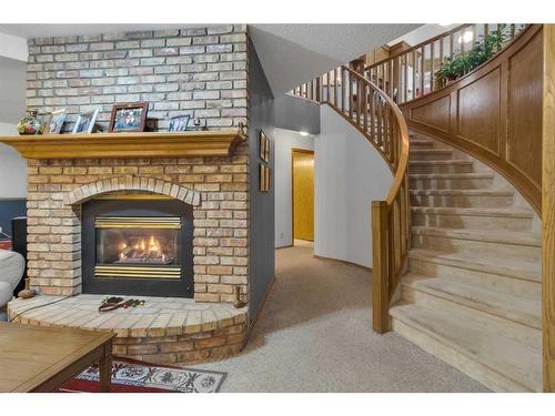 232 Hampshire Place Nw, Calgary, AB - Indoor Photo Showing Living Room With Fireplace