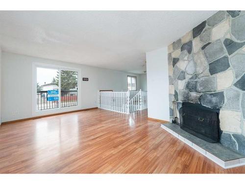 1-1412 43 Street Se, Calgary, AB - Indoor Photo Showing Living Room With Fireplace