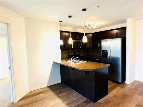 2319-175 Panatella Hill, Calgary, AB - Indoor Photo Showing Kitchen With Double Sink