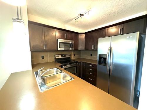 2319-175 Panatella Hill, Calgary, AB - Indoor Photo Showing Kitchen With Double Sink