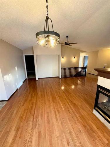 110 Riverside Place Nw, High River, AB - Indoor With Fireplace