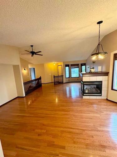 110 Riverside Place Nw, High River, AB - Indoor With Fireplace