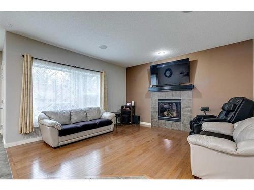 136 Cougartown Close Sw, Calgary, AB - Indoor Photo Showing Living Room With Fireplace