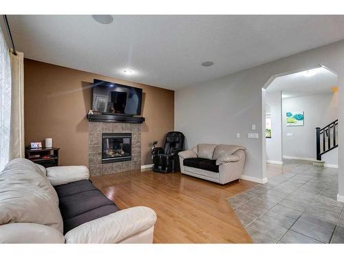 136 Cougartown Close Sw, Calgary, AB - Indoor Photo Showing Living Room With Fireplace