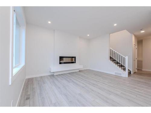 70 Cobbleridge Place Sw, Airdrie, AB - Indoor Photo Showing Living Room With Fireplace