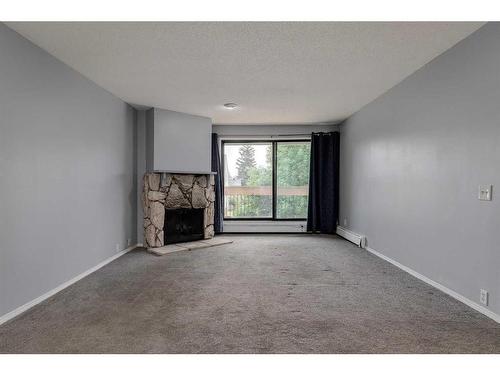 121-10120 Brookpark Boulevard Sw, Calgary, AB - Indoor With Fireplace