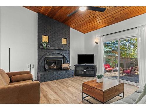 125 Woodbend Way, Okotoks, AB - Indoor Photo Showing Living Room With Fireplace