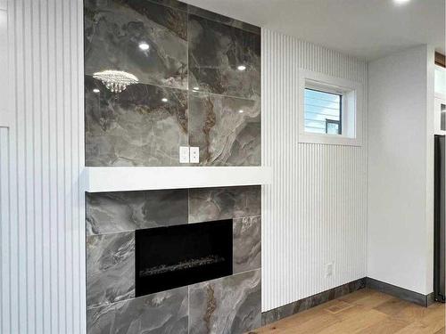 105 Hartford Road Nw, Calgary, AB - Indoor Photo Showing Living Room With Fireplace