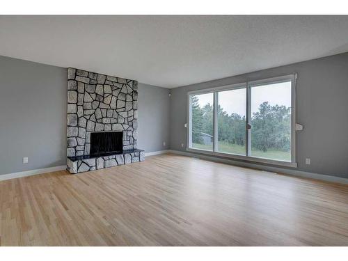 240090 370 Avenue West, Rural Foothills County, AB - Indoor Photo Showing Living Room With Fireplace