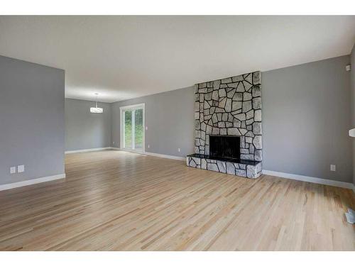 240090 370 Avenue West, Rural Foothills County, AB - Indoor Photo Showing Living Room With Fireplace