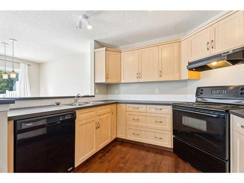 73 Rocky Ridge Heath Nw, Calgary, AB - Indoor Photo Showing Kitchen With Double Sink